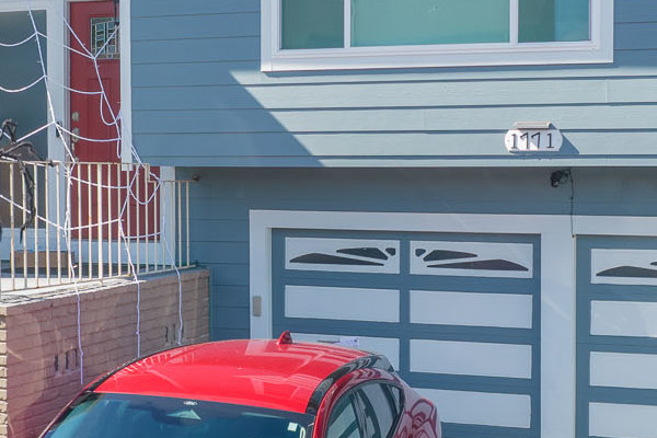 Coastal-style home in San Bruno with Boothbay Blue HardiePlank siding and Arctic White trim, featuring two parked cars