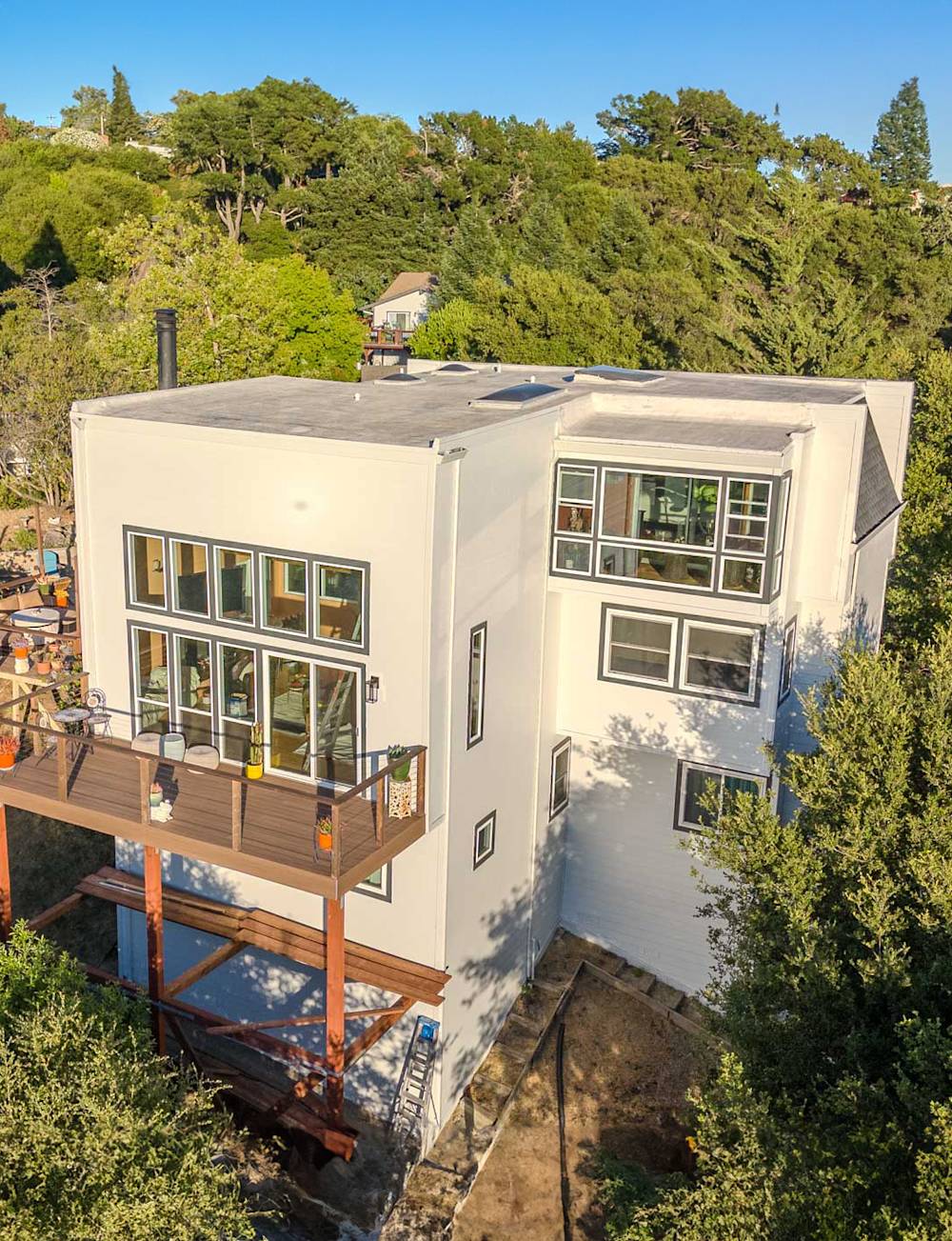 Fresh white facade, modern windows, and inviting wooden deck