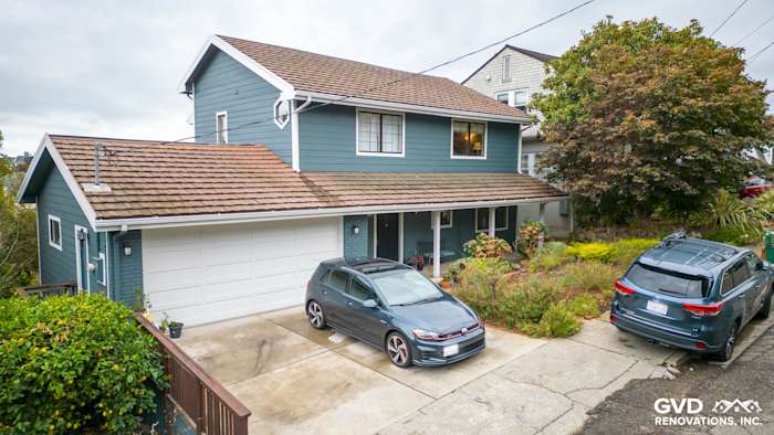 Oakland home with James Hardie Evening Blue siding and Arctic White trim, featuring a two-car driveway