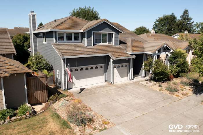 Two-story home in Petaluma renovated with Night Grey James Hardie siding and Arctic White trim, showcasing vinyl windows