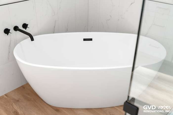 Modern freestanding bathtub with black fixtures, surrounded by marble tiles and wooden flooring in a Paradise bathroom