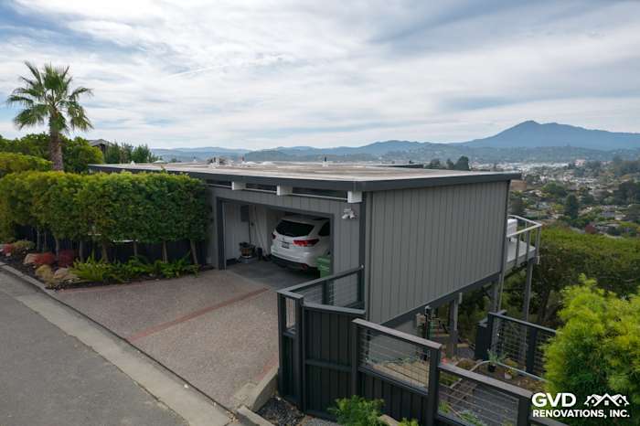 Modern home exterior with new T1-11 siding, large windows, and scenic hillside views in San Rafael, CA