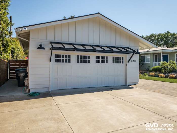 Updated home exterior in Novato featuring new James Hardie Board and Batten siding with a modern garage door