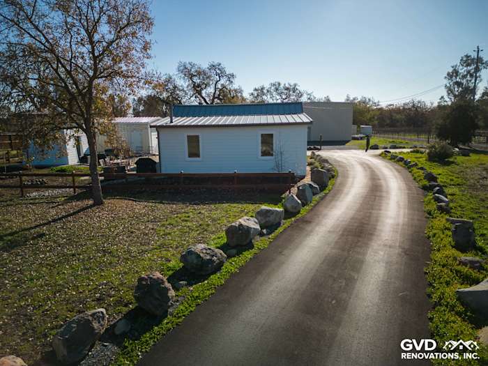 Home exterior in Sonoma with new Arctic White James Hardie siding, paved driveway, and landscaped yard