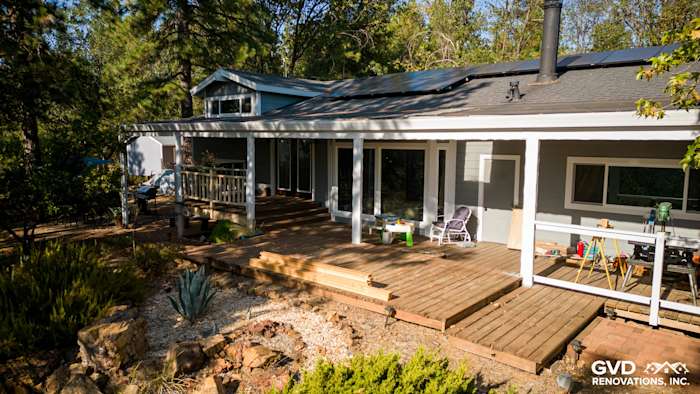 Gray Slate James Hardie siding and Arctic White trim accentuate this updated home exterior with a wooden deck