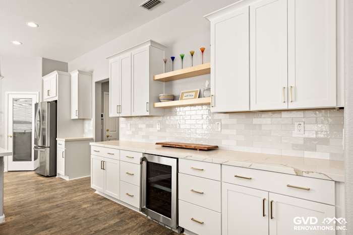Modern kitchen featuring white Diamond cabinets, MSI countertops, floating shelves, and stylish backsplash in Roseville, CA