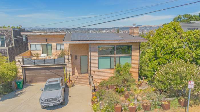 Stylish home exterior featuring Natural Cedar Beveled Plank Siding and new deck railing in Richmond, CA