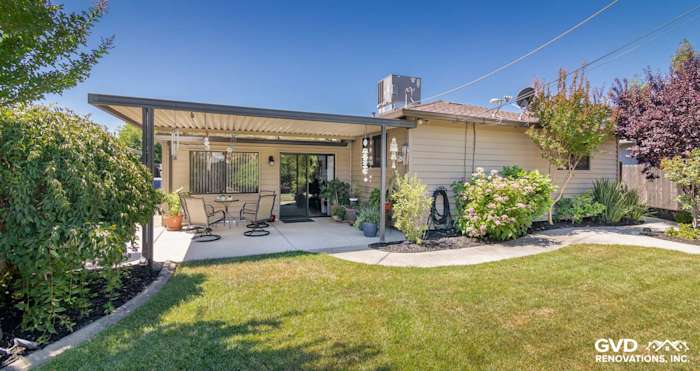 Home exterior featuring new Alside Prodigy vinyl siding, covered patio, and landscaped garden in Rio Linda, CA