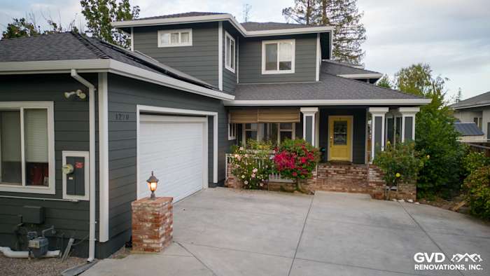 Home exterior featuring James Hardie Pearl Gray siding with Arctic White trim and a yellow door in Campbell, CA