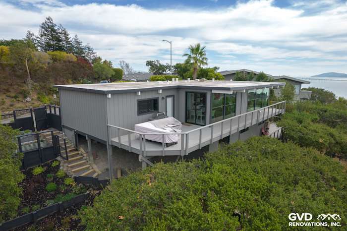 Modern home exterior featuring new T1-11 siding, large windows, and a spacious deck in San Rafael