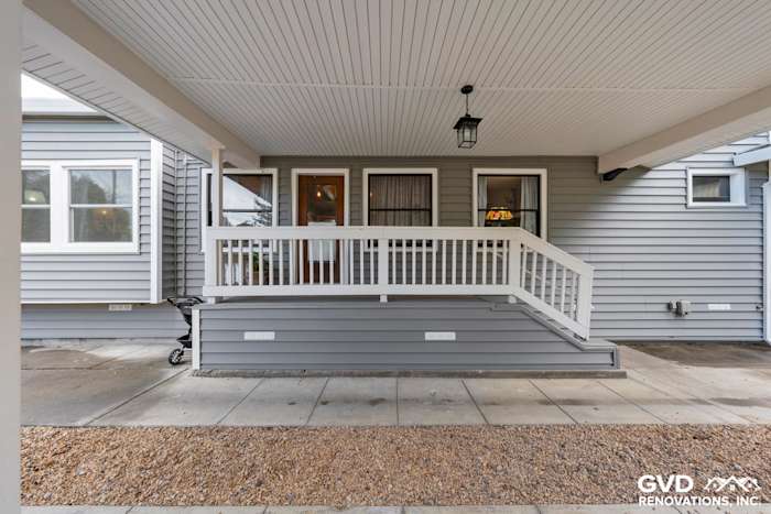 Modern vinyl siding renovation with gray tones and white trim, featuring a porch entrance in Dixon, CA