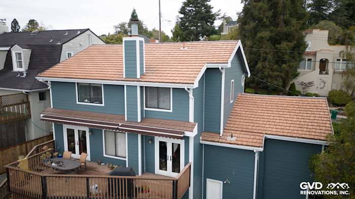 Two-story home exterior in Oakland featuring Evening Blue HardiePlank siding and rustic Arctic White HardieTrim accents