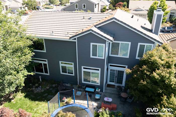Two-story home exterior featuring Night Grey James Hardie siding and Arctic White trim with multiple vinyl windows