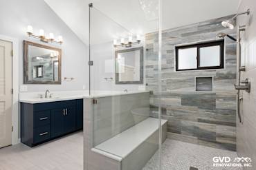Spacious master bathroom in Fair Oaks with dual sinks, large glass shower, and modern tile accents