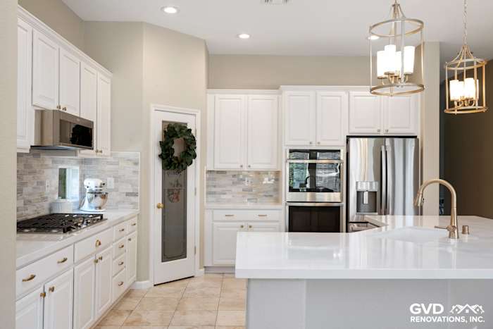 Modern Sacramento kitchen remodel featuring white cabinets, quartz countertops, stainless steel appliances, and mosaic tile