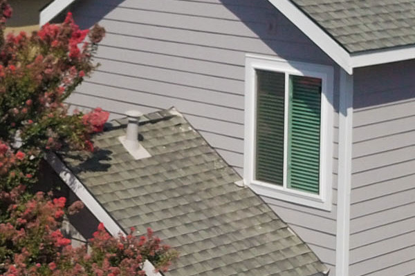 Contemporary home exterior featuring Pearl Gray HardiePlank Lap Siding and Arctic White trim in Davis, CA