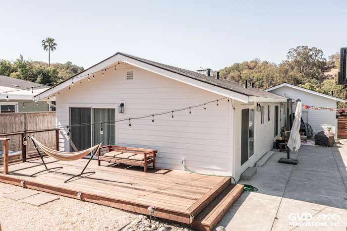 Updated home exterior featuring new James Hardie Board and Batten siding in Novato, CA, with a modern deck and string lights