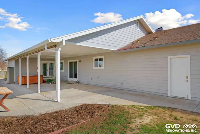 Pearl Gray James Hardie siding and Arctic White trim on a Galt home’s exterior, featuring a covered patio