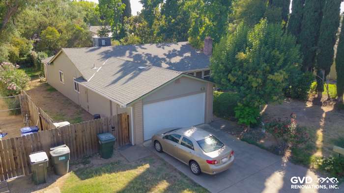 Home exterior featuring Monterey Taupe HardiePlank Lap Siding, garage, and well-maintained landscaping in Orangevale