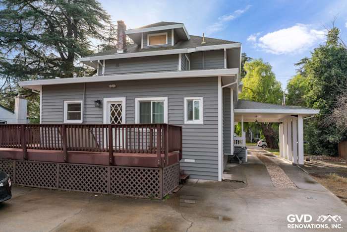 Modern gray vinyl siding renovation on a two-story home with a wooden deck in Dixon, CA