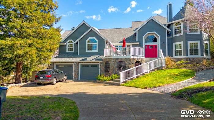 Home exterior featuring Night Gray James Hardie siding, Arctic White trim, and a red front door in Petaluma