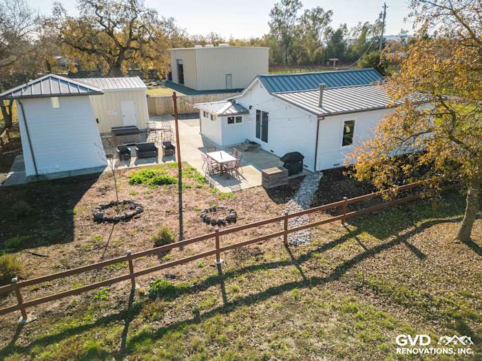 Sonoma home with new Arctic White James Hardie siding and landscaped backyard, featuring a patio and outdoor grill