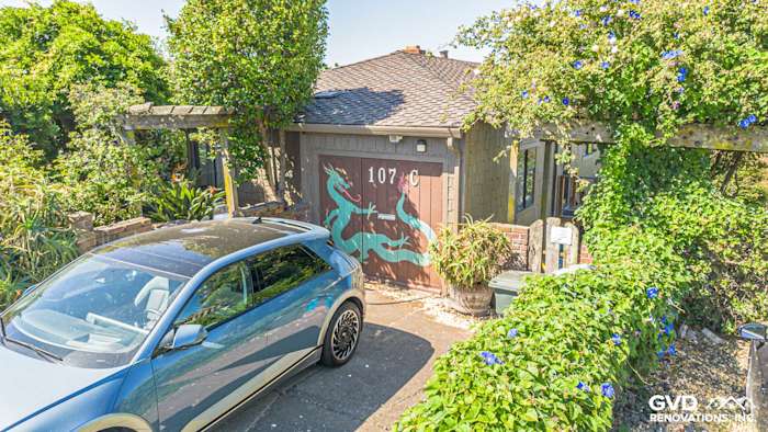 Updated home exterior featuring James Hardie Shake and Shingle Siding in Vallejo, CA with greenery and driveway