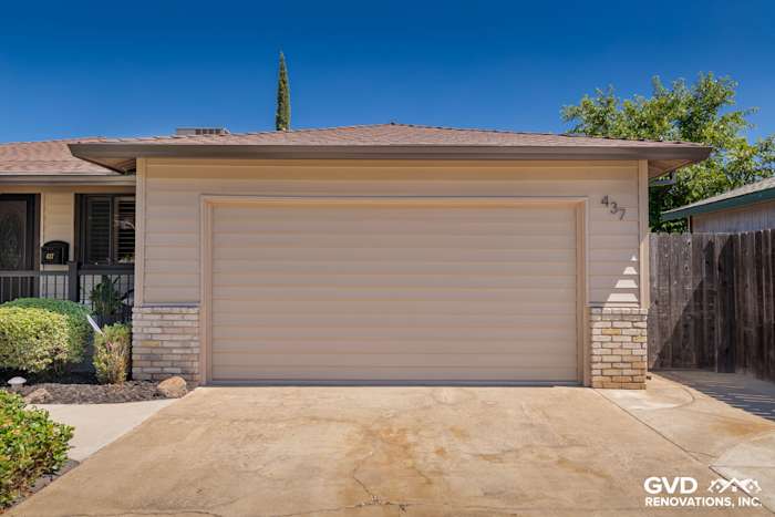 Modern home exterior featuring new beige Alside Prodigy vinyl siding and matching garage door in Rio Linda, CA