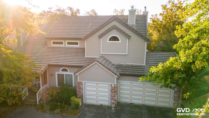 Sonoma home exterior with James Hardie Cedarmill siding and Alside vinyl windows, featuring a detailed roof design