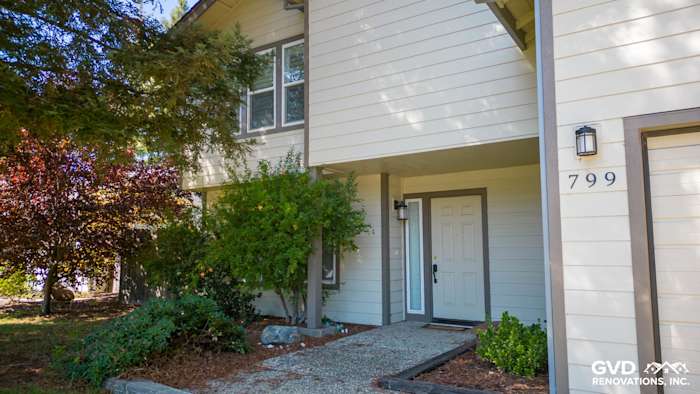 Front entrance of a Sacramento home with James Hardie siding, landscaped pathway, and modern door design