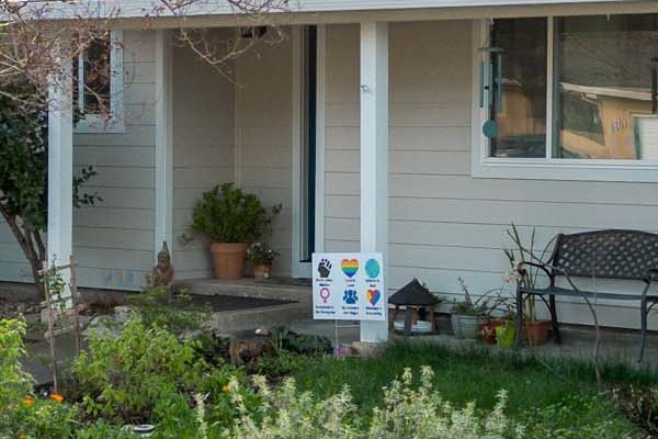 Updated home exterior in Napa featuring James Hardie Cobble Stone siding, Arctic White trim, and a white picket fence