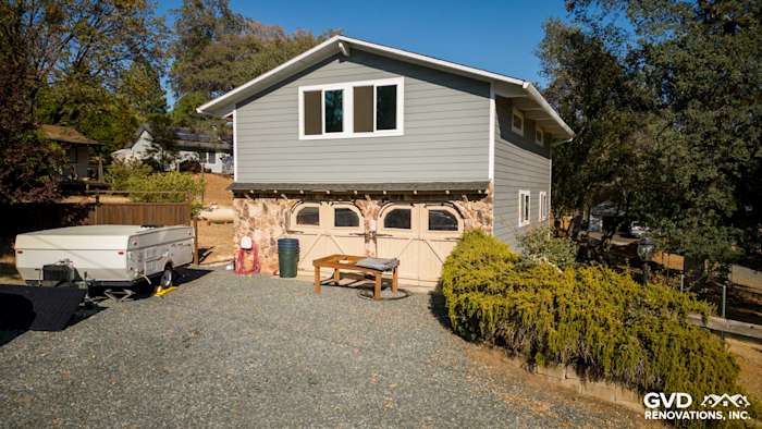 Home exterior featuring Gray Slate James Hardie siding and Arctic White trim with Milgard windows in Meadow Vista