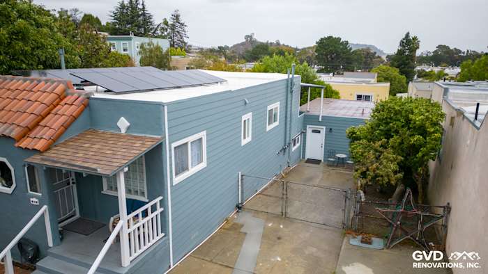 Brisbane home exterior featuring Boothbay Blue HardiePlank siding and Arctic White trim, with solar panels visible