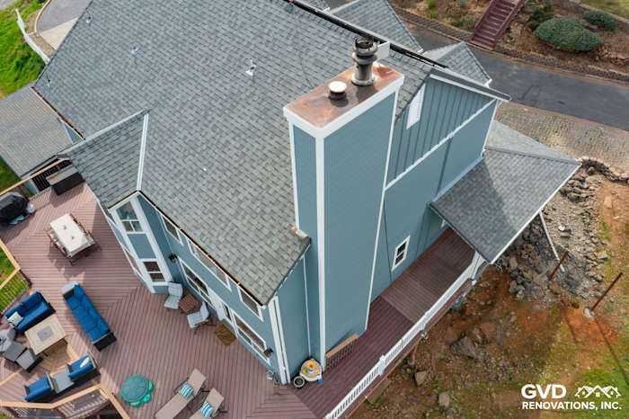 Freshly installed James Hardie siding in light blue covering a modern home with a spacious deck in Shingle Springs
