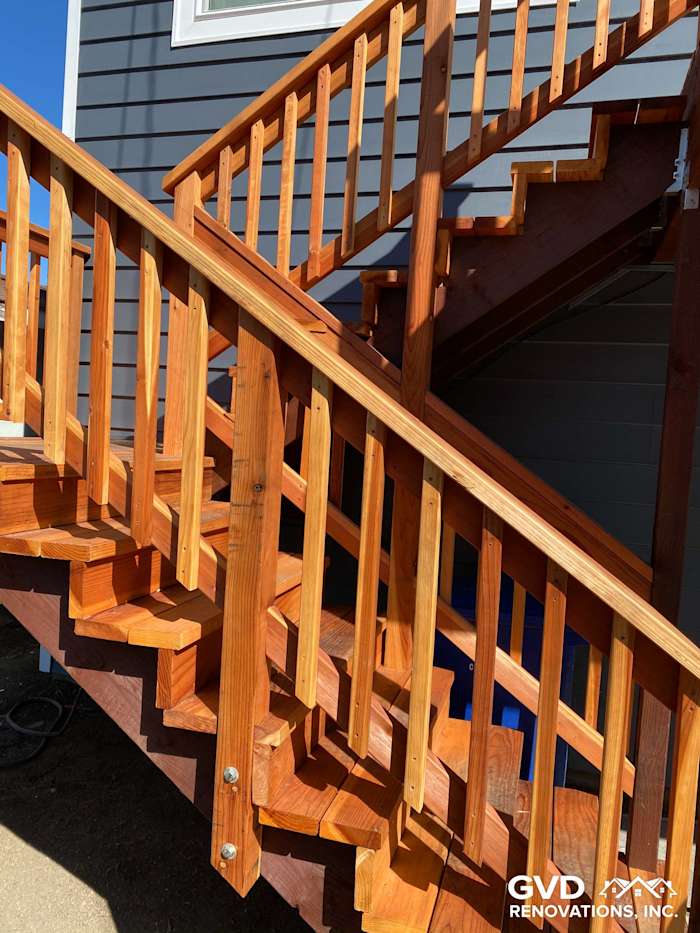 Sturdy wooden deck stairs with vertical railings, featuring a rich wood finish in Rio Vista