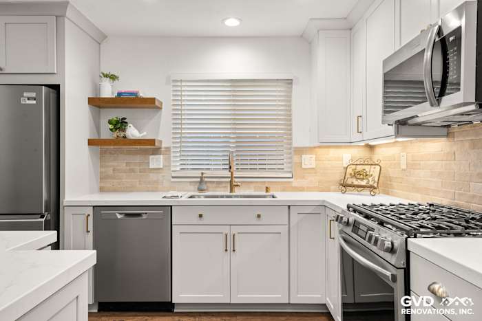 Modern kitchen in Roseville featuring Waypoint cabinetry, Vadara Naurelle stone countertops, and MSI Brickstone Ivory