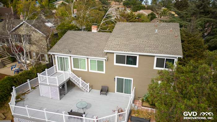 Back view of a home featuring Timber Bark HardiePlank siding and Arctic White HardieTrim with a spacious deck