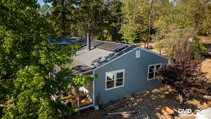 Gray Slate James Hardie siding and Milgard windows on a renovated home in Meadow Vista surrounded by trees