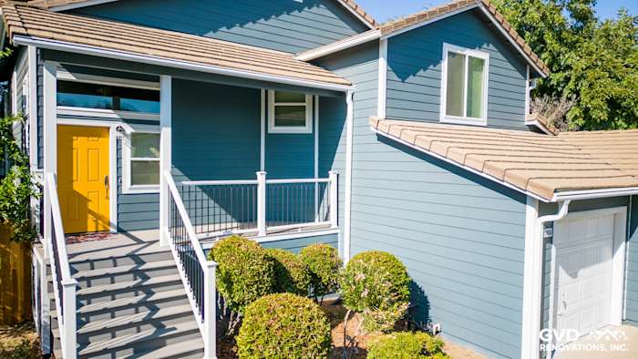 Newly installed blue siding, Anlin windows, and updated front deck with side steps in Dixon, CA