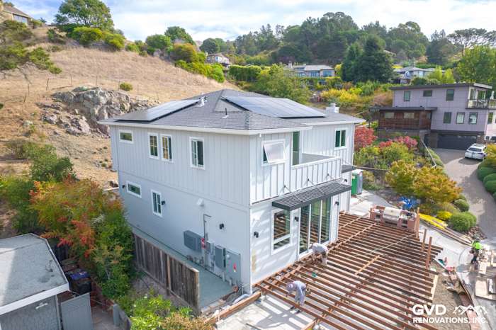 Tiburon home's exterior with newly installed James Hardie Artisan Lap Siding and wood deck under construction