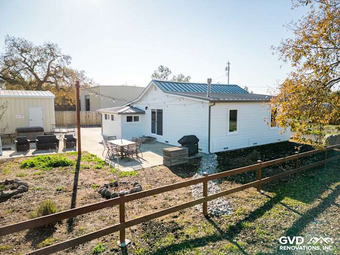 Fresh Arctic White James Hardie siding on a remodeled Sonoma home, showcasing a clean, modern exterior and backyard