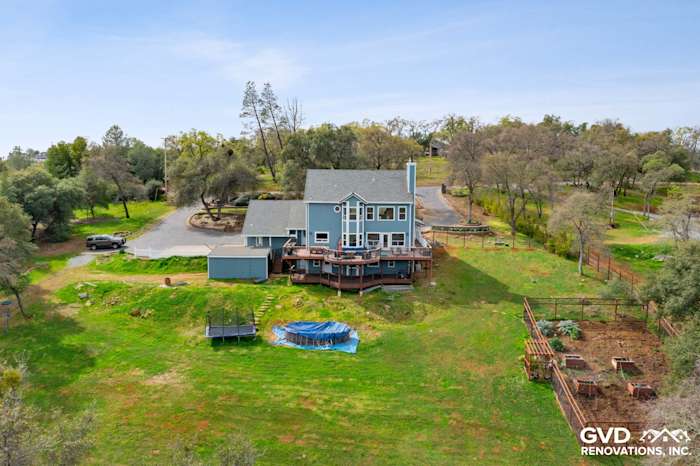 Aerial view of a home in Shingle Springs with newly installed James Hardie siding and spacious deck