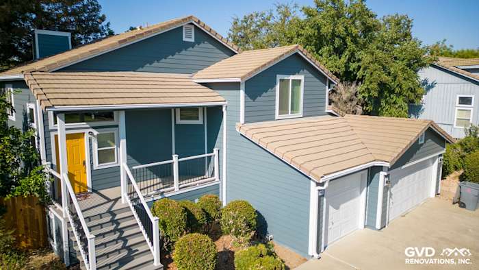 New blue siding and Anlin windows enhance this Dixon, CA home's exterior, featuring a stylish deck and side steps
