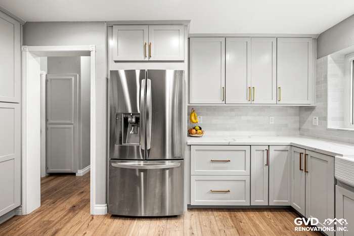 Modern kitchen remodel with gray custom cabinets, stainless steel refrigerator, and quartz countertops in El Dorado Hills