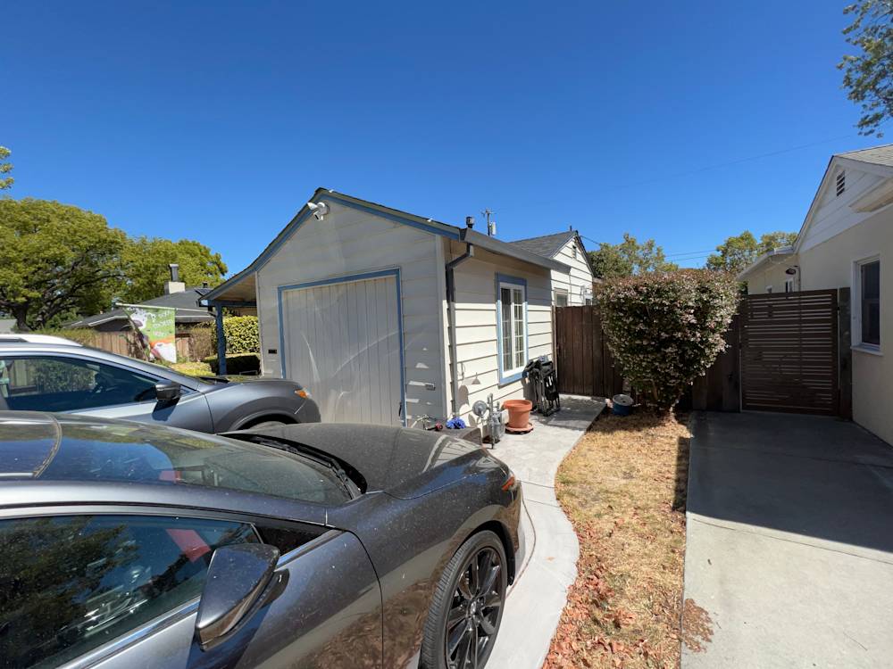 Old garage with faded siding and unkempt landscaping in Sacramento