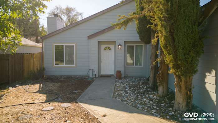 Light blue James Hardie siding on home exterior, featuring new entryway and landscaped path in Sacramento