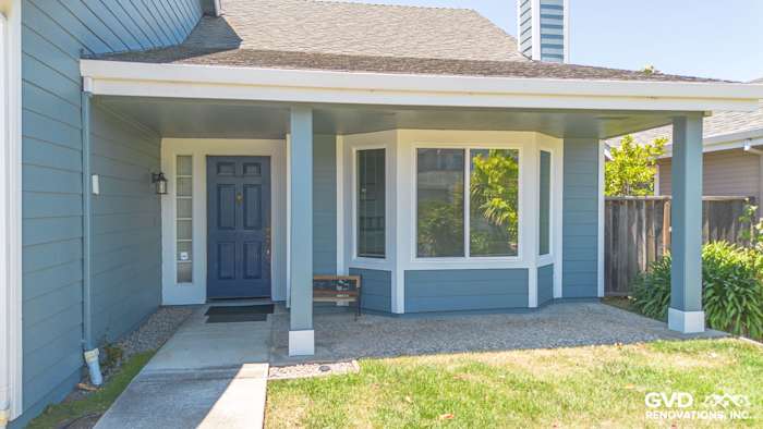 Foster City home with new Boothbay Blue James Hardie siding and Arctic White trim, featuring a welcoming porch and bay window