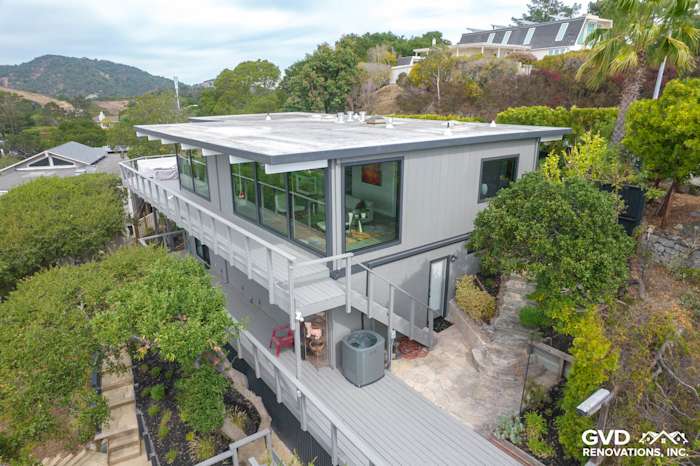 Modern two-story home with T1-11 siding, large windows, and landscaped deck in San Rafael, CA