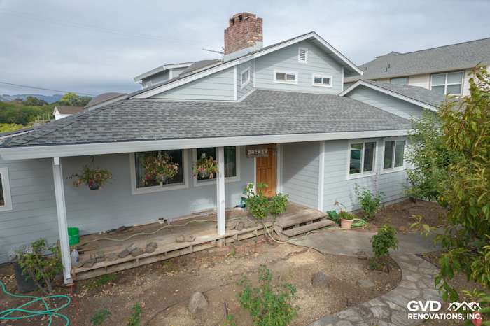 Light Mist James Hardie siding with Arctic White trim on a Sonoma home exterior, featuring a welcoming porch and landscaping