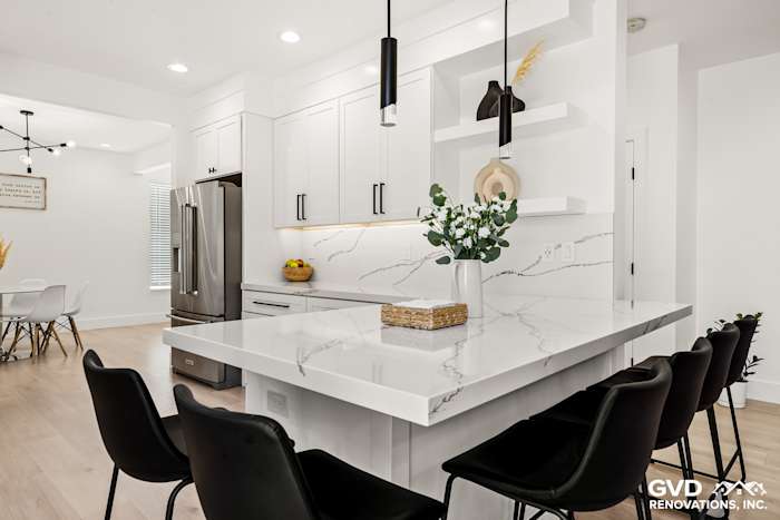 Modern kitchen in Antelope, CA featuring quartz countertops, custom cabinets, and sleek black bar stools